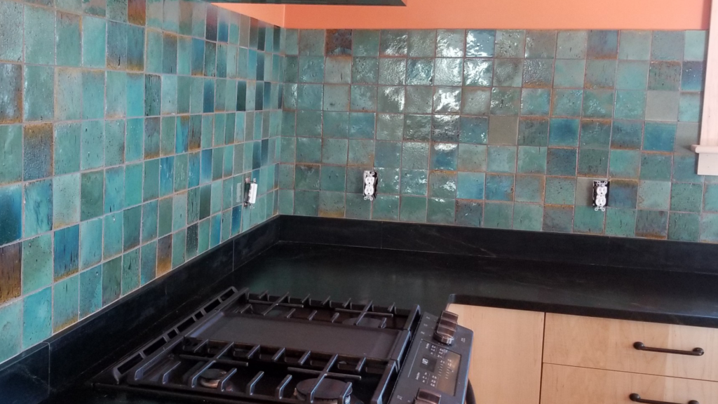 Shades of blues and aqua tiles expertly installed in kitchen