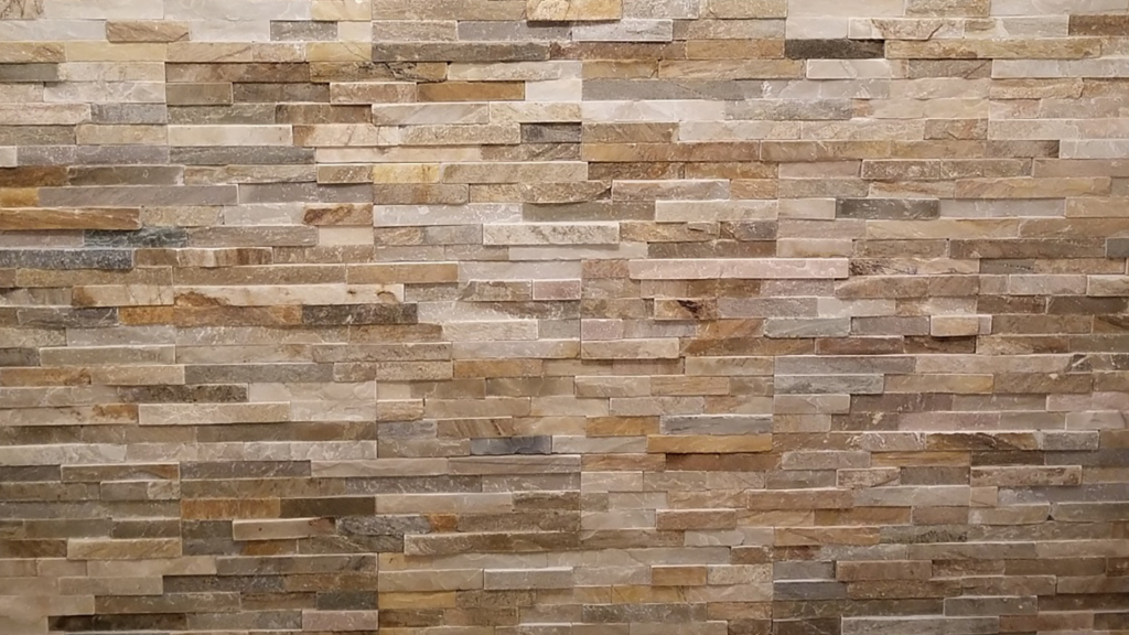 Professional installation of wall of brown toned slate tiles